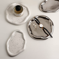 Silver and white sculptural ceramic trinket trays styled with jewellery