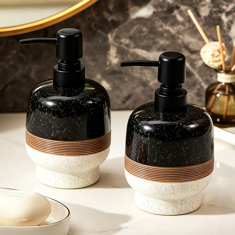Black and cream ceramic soap dispenser with bronze detail