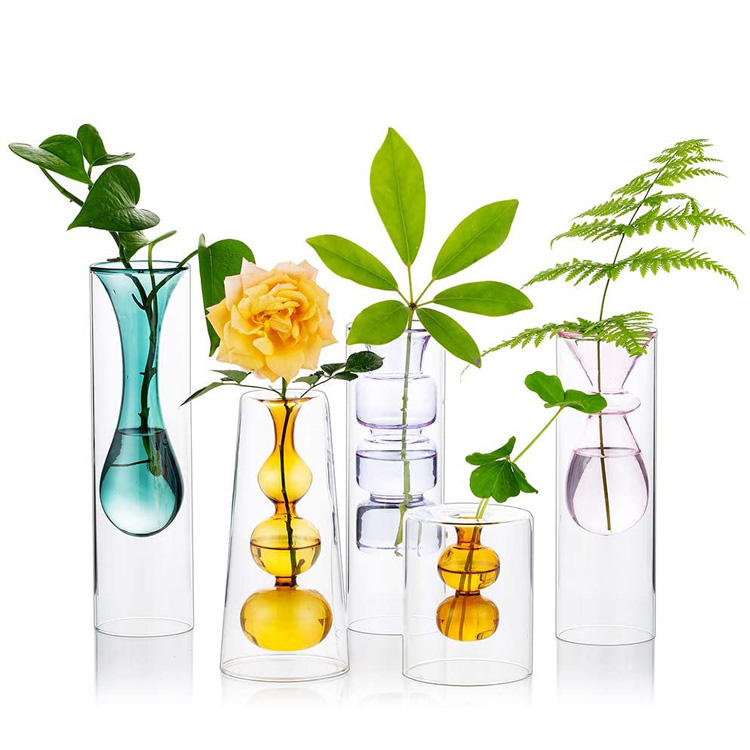Collection of colourful double-layer glass bud vases with flowers