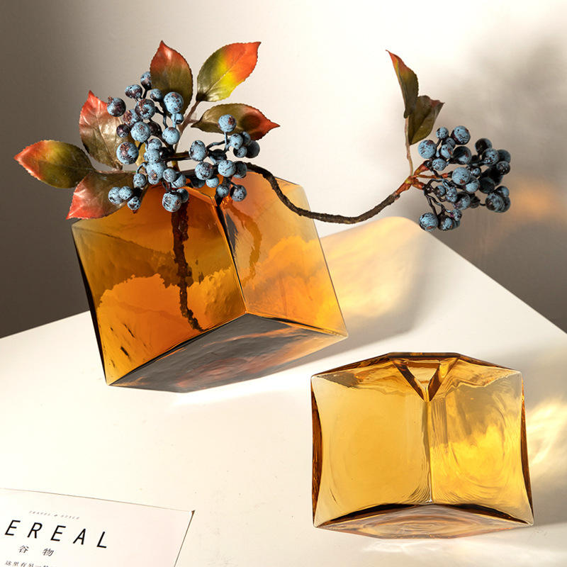 Amber glass vase styled with berries and leaves