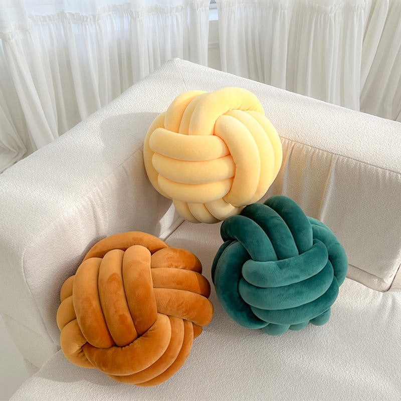 Ochre cream and green knot cushions