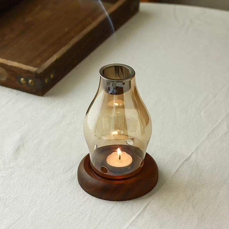 Amber glass candle and incense holder on wooden base