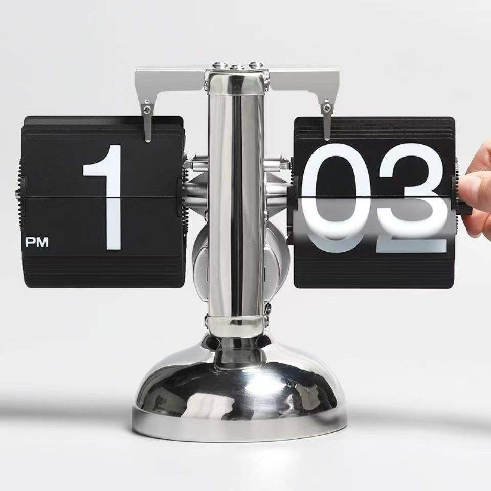 Closeup of retro silver flip clock with black number cards