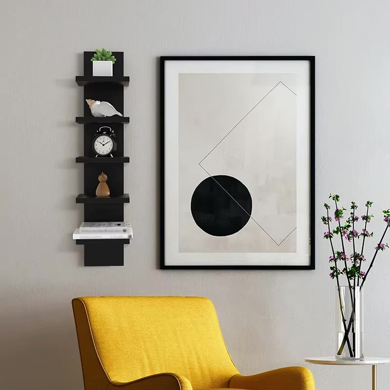 Black five-tier vertical floating wall shelf styled with plants and ornaments